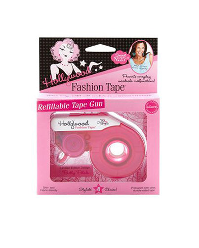 A pink Hollywood Fashion Tape Refillable Tape Gun in its original packaging offers clear, double-sided tape to prevent everyday wardrobe malfunctions.