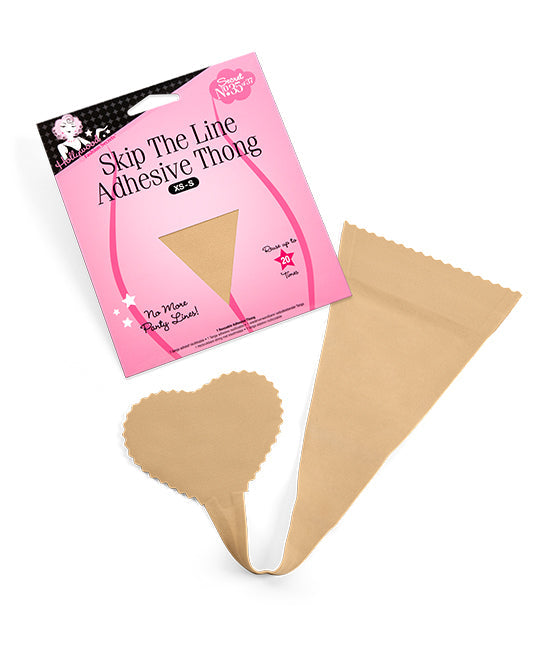 A nude Hollywood Fashion Secrets adhesive thong rests next to its pink packaging, showcasing a reusable, strapless solution for avoiding visible panty lines.