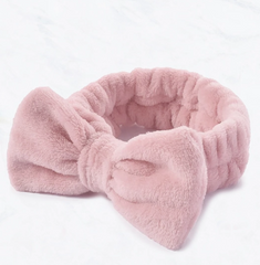 Pink plush headband on a white background
