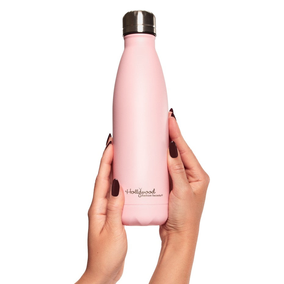 Pink water bottle held by a hand model on a white background