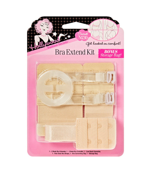 A Hollywood Fashion Secrets Bra Extend Kit displays an assortment of beige bra extenders, clear straps, and a bra converting clip inside its pink retail packaging.