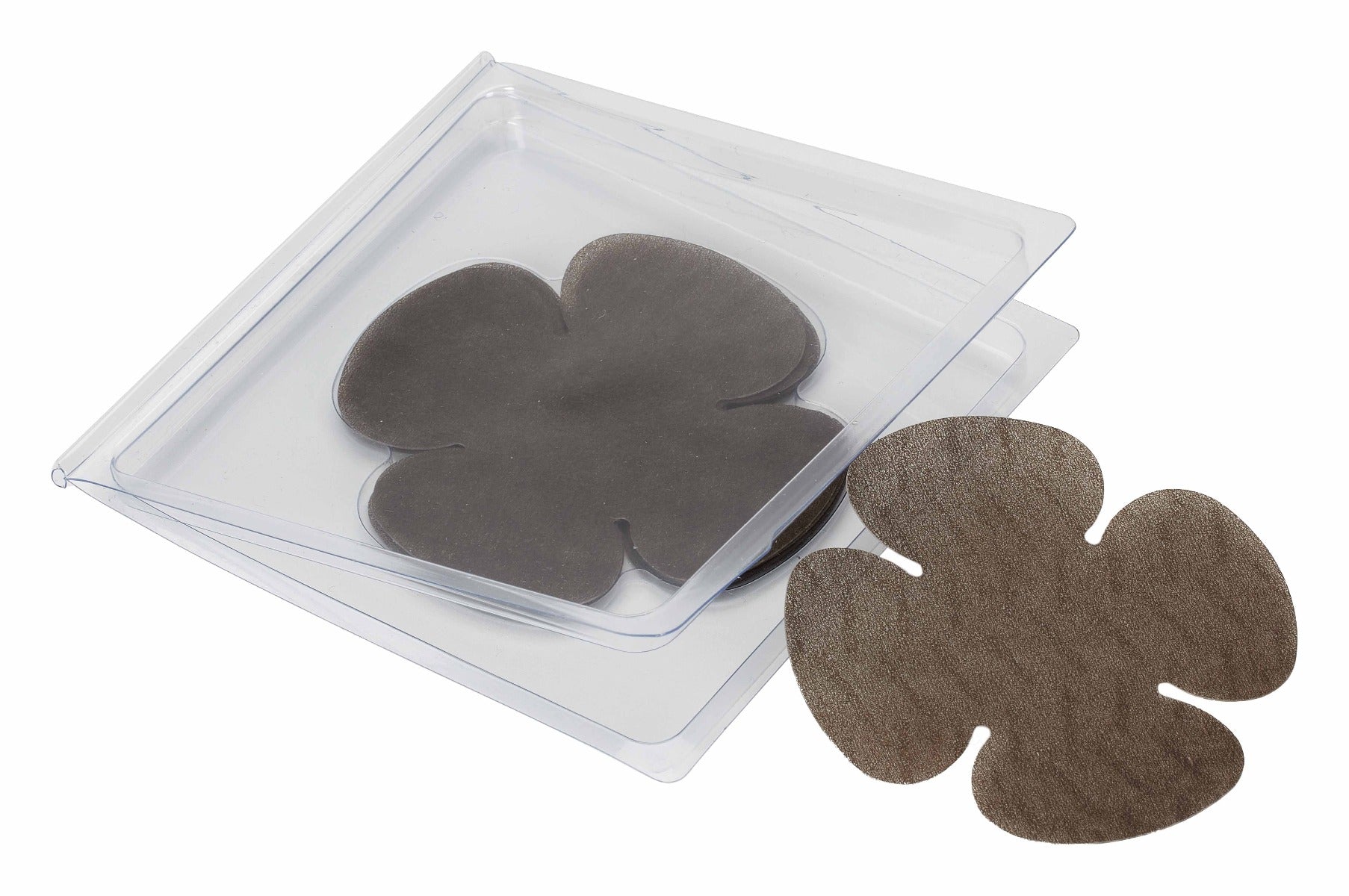 A dark brown, flower-shaped adhesive nipple cover rests beside its clear plastic storage tray.