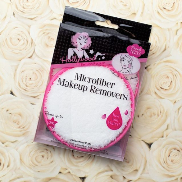 A package of Hollywood Fashion Secrets Microfiber Makeup Removers rests on a bed of soft white roses.