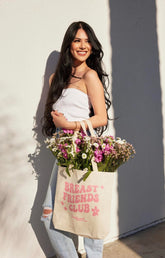 Image of Hollywood Fashion Secrets Breast Friends Canvas Tote front facing with printed Breast Friends Club graphic on model's arm