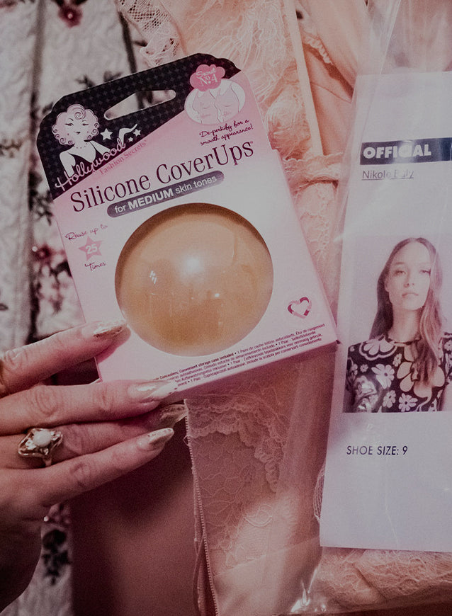 Silicone coverup packaging held by a hand with a blurred background