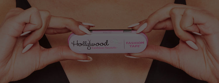 Female holding fashion tape against a pink background