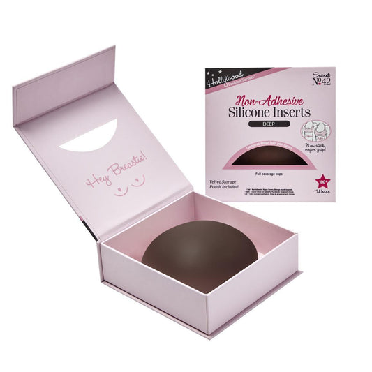 A deep-toned Hollywood Fashion Secrets non-adhesive silicone breast insert rests inside an open pink storage box next to its retail packaging.