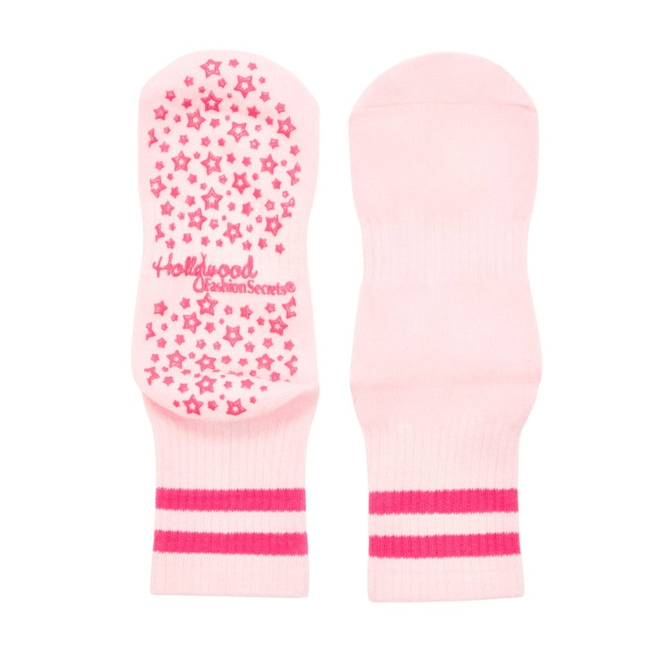 Pink grip socks with star pattern and 'Hollywood Secret' branding on a white background