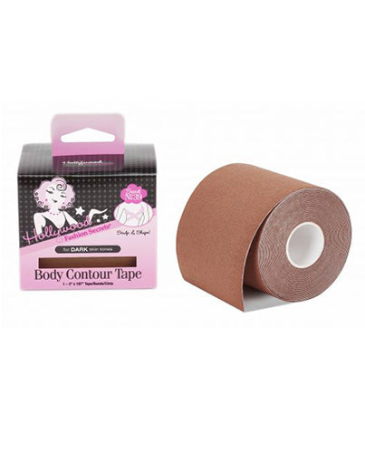 A roll of brown Hollywood Fashion Secrets Body Contour Tape sits next to its pink and black box designed for dark skin tones.