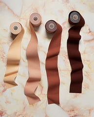 4 rolls of adhesive tape for body contour  for all skin tones  lay on the floor