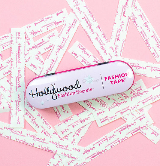 Hollywood Fashion Secrets fashion tape tin displayed on a pink background with branded tape strips.