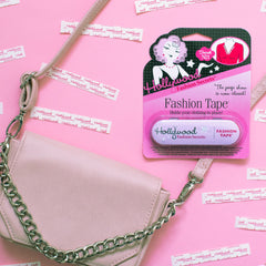 Hollywood Fashion Tape displayed with a purse and strips of tape, showcasing its compact and portable design.