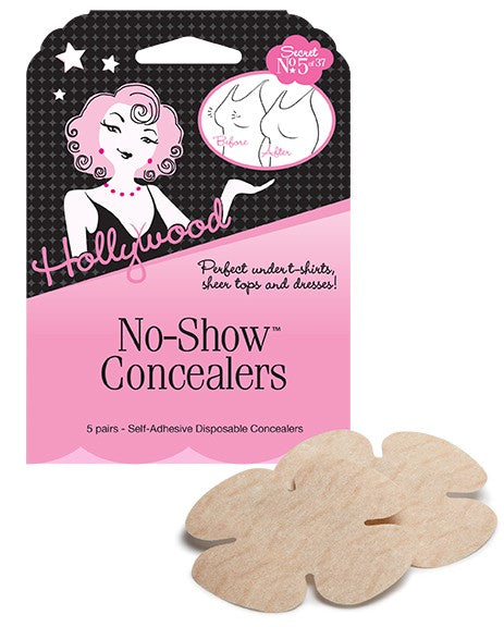 Two tan, flower-shaped Hollywood No-Show Concealers sit in front of their pink and black product packaging.