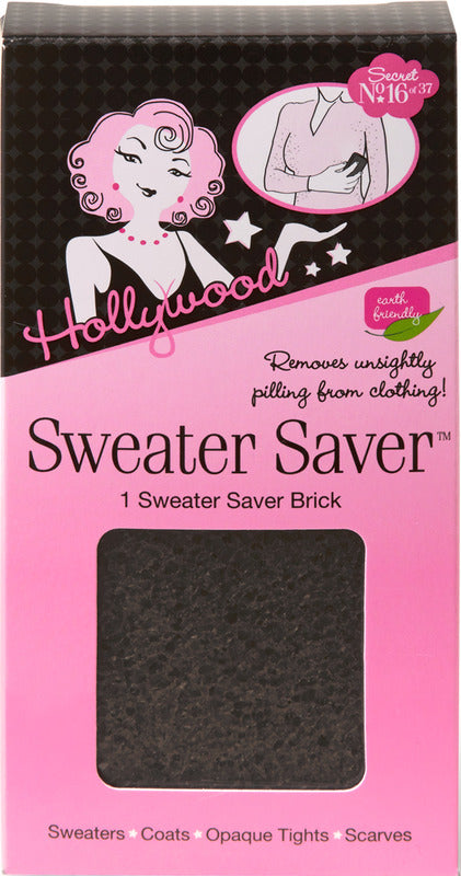 The pink and black packaging for the Hollywood Sweater Saver features a cutout window displaying a textured black brick designed to remove pilling from clothing.