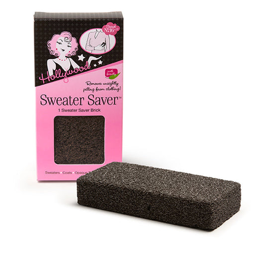 A grey pumice sweater stone sits beside its pink Hollywood Sweater Saver packaging, ready to remove lint and pilling from clothing.