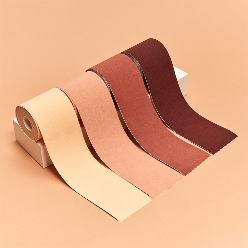 Three rolls of sandpaper in beige, brown, and red on a peach background