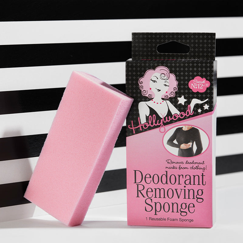 Pink deodorant removing sponge with packaging on a black and white striped background