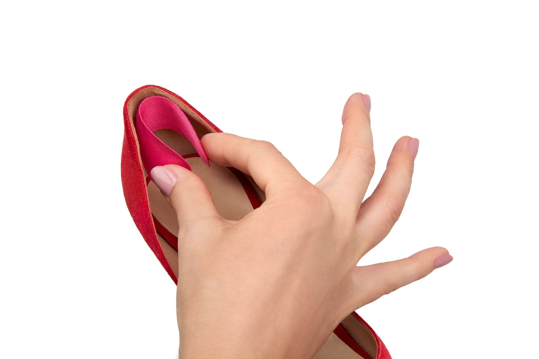 A woman holding and putting heel liners on shoes