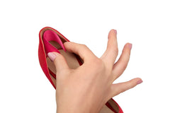 A woman holding and putting heel liners on shoes