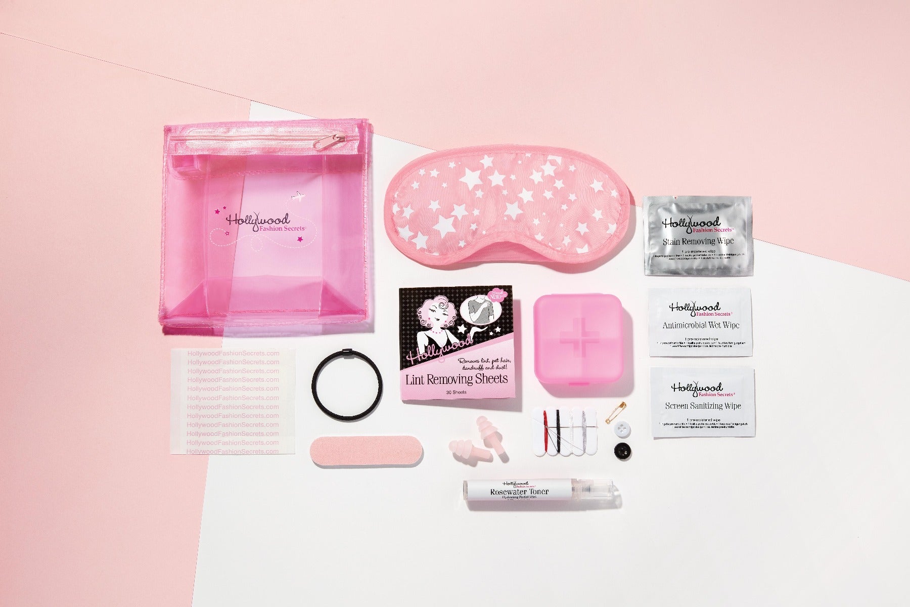 Hollywood Fashion Secrets travel essentials kit with pink sleep mask, lint sheets, wipes, and storage pouch for on-the-go beauty fixes.