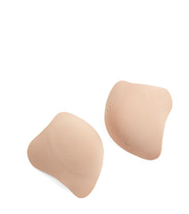 Close-up of Silicone Contour Cups, reusable self-adhesive bra pads in natural color.