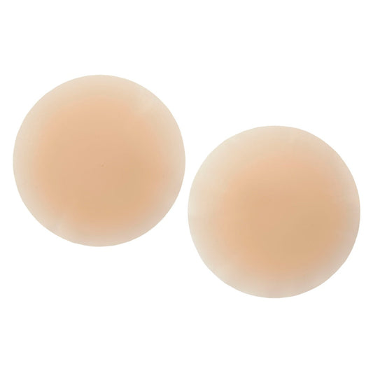 A pair of round, skin-toned silicone nipple covers provide a discreet and reusable adhesive coverage solution.