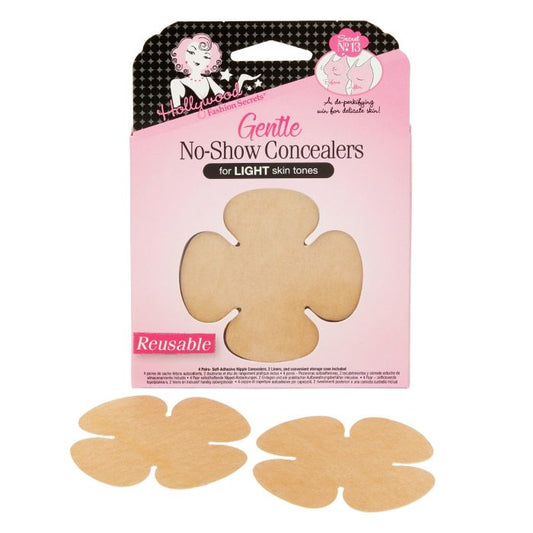 Two flower-shaped, reusable tan nipple covers sit in front of a pink box of Hollywood Fashion Secrets Gentle No-Show Concealers for light skin tones.